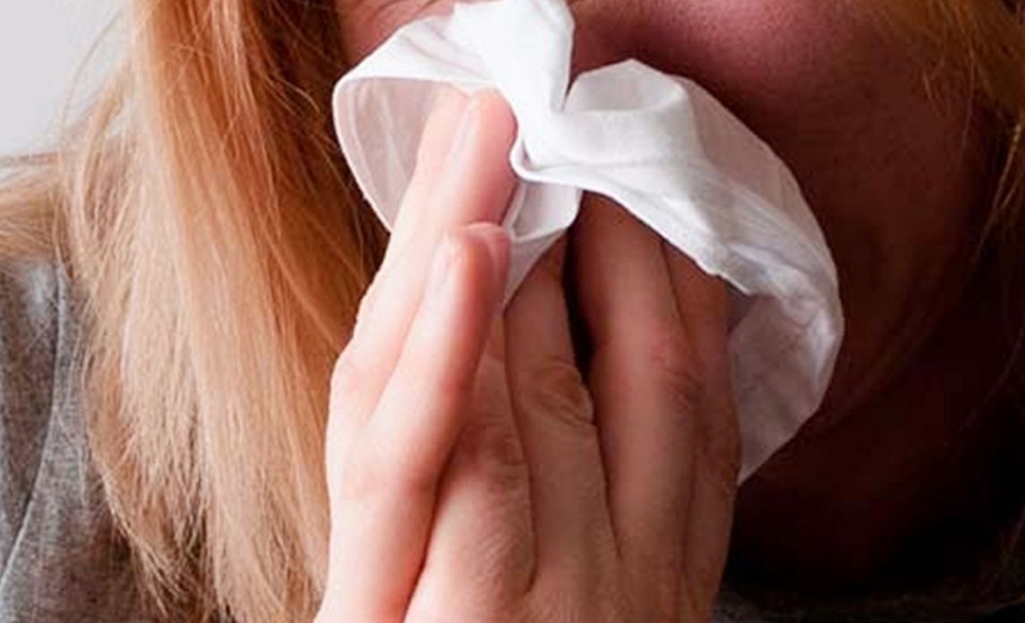 Sneezing and covering nose